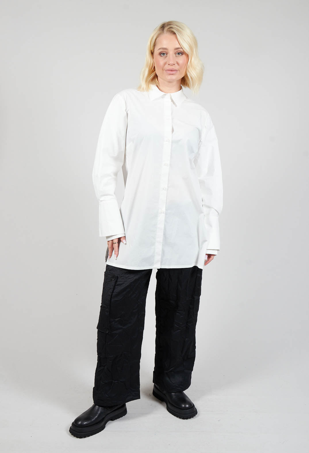 lady wearing an off white blouse with long sleeves