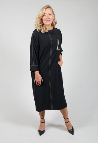 lady wearing a black shift dress