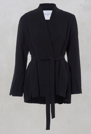 collarless tailored navy jacket with tie waist belt