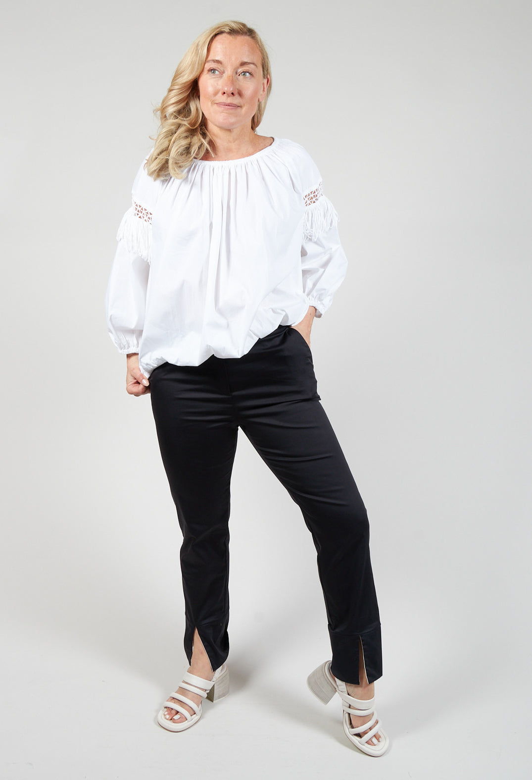 lady smiling wearing some black tailored trousers
