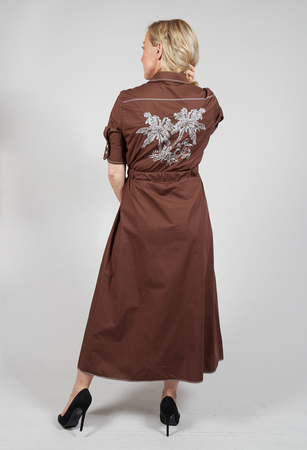 lady wearing brown shirt dress with embroidery detail