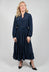 lady wearing a blue tiered maxi dress with tie waist belt