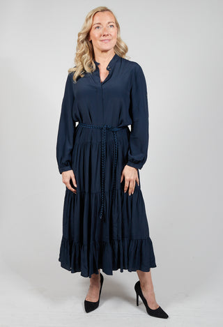 lady wearing a blue tiered maxi dress with tie waist belt
