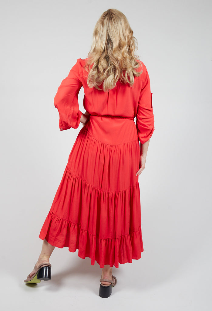 lady wearing a red tiered maxi dress