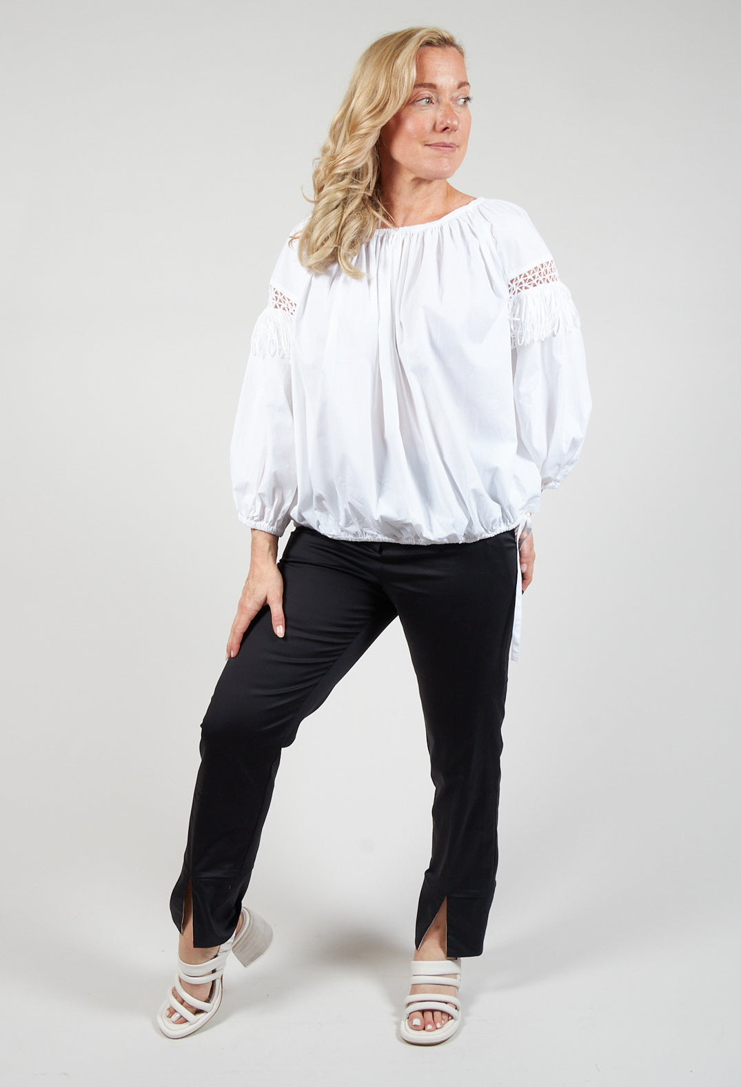 lady wearing a pretty white blouse with fringe open work detail