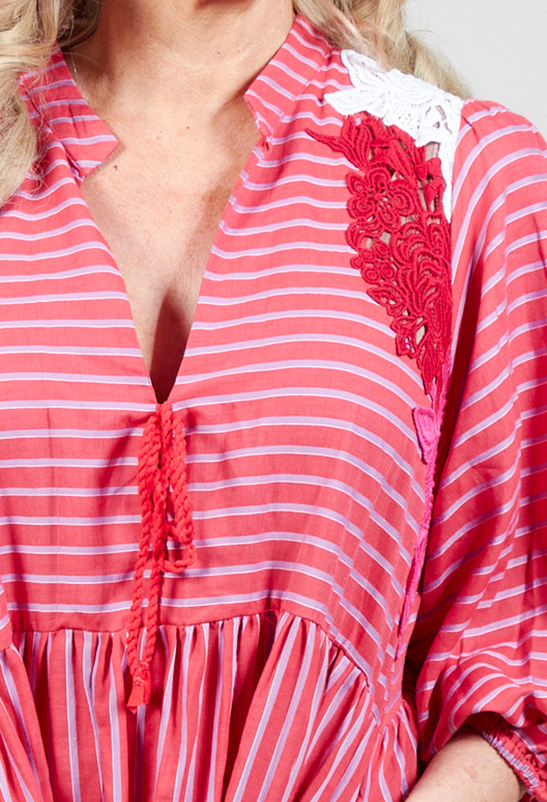 close up of striped lace dress in fuchsia