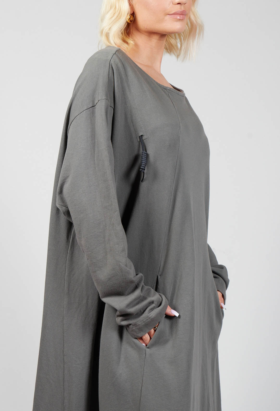 side shot of a grey jersey dress with a round neck