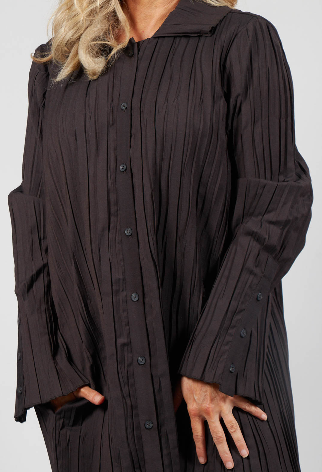 close up of a dark wood ladies blouse with buttons and side pockets