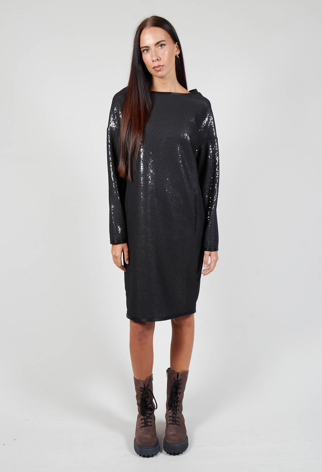 lady wearing a black sparkly vita dress with long sleeve detailing and chunky boots