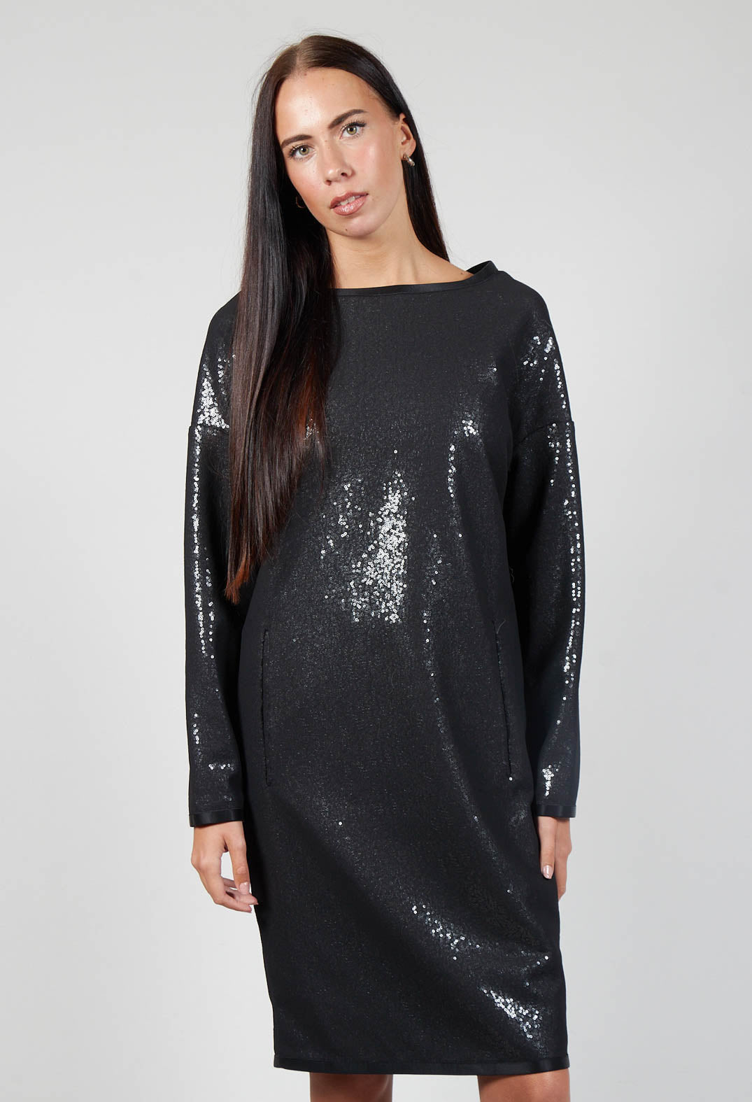 lady posing in a black sparkly vita dress with long sleeves