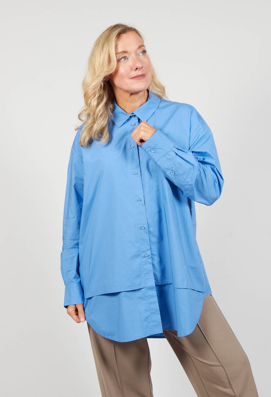 lady wearing a sky blue blouse with long sleeves
