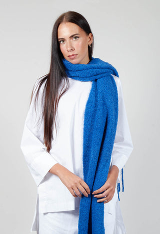 lady wearing a runa scarf in blue over a white long sleeve top