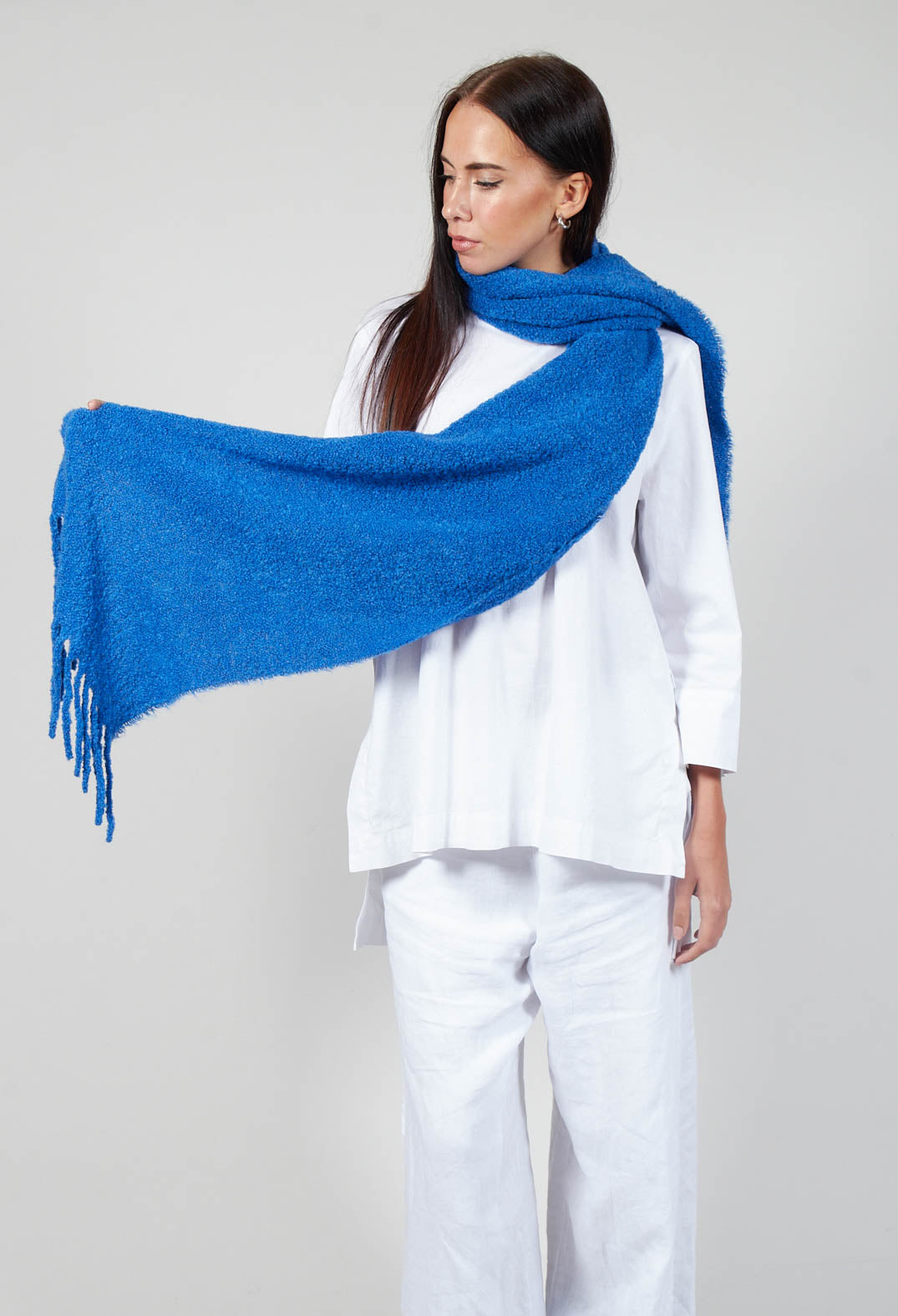 lady holding a runa scarf in deep sky blue