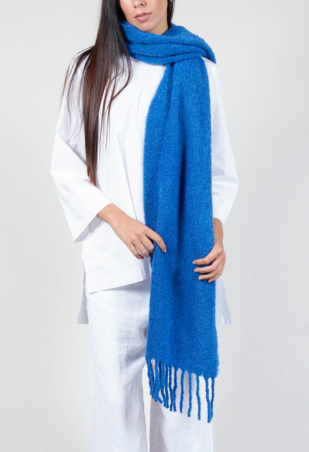 lady wearing a deep sky blue scarf over a long sleeve white top