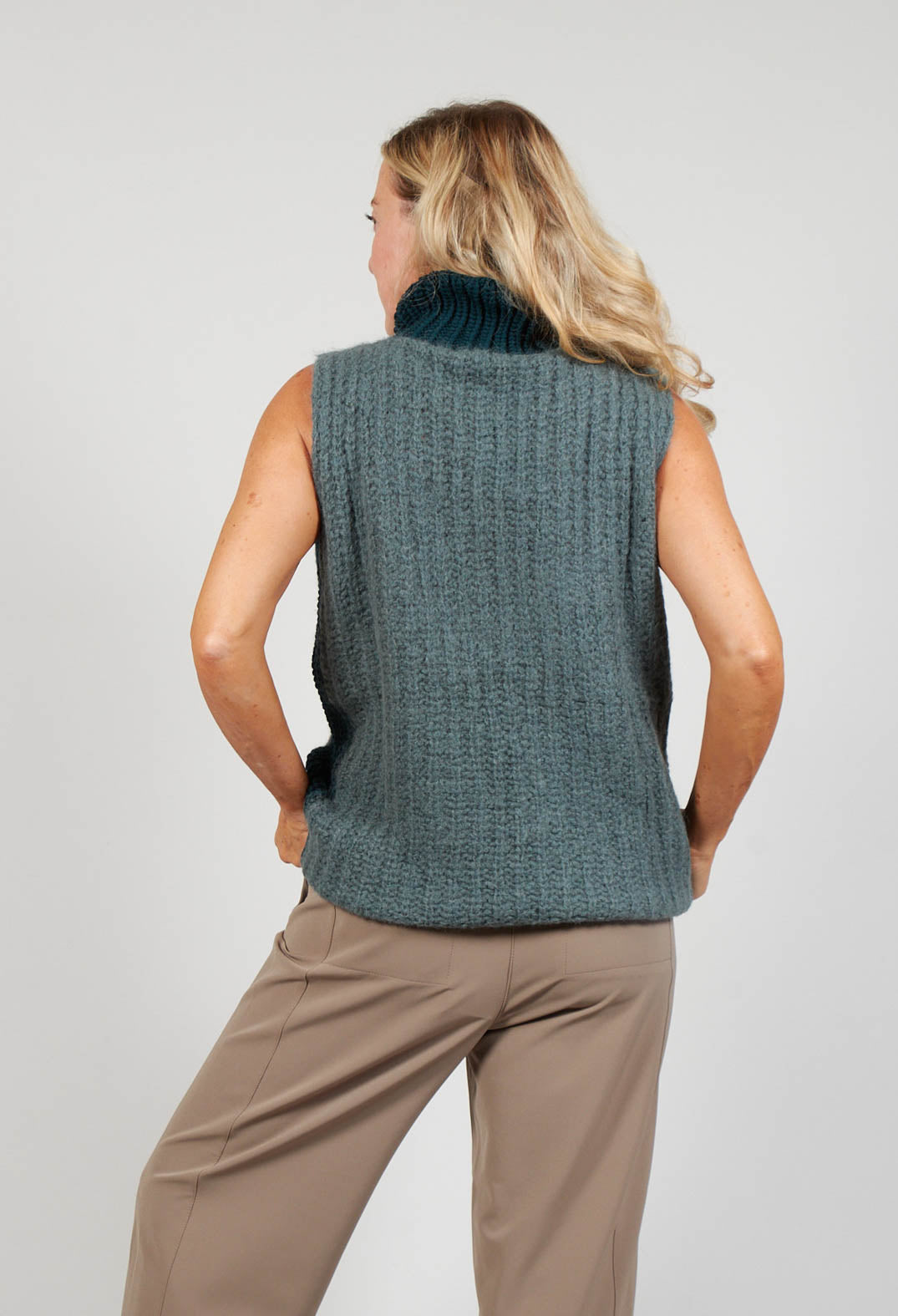 behind shot of a green and grey patterned ladies sleeveless knit jumper