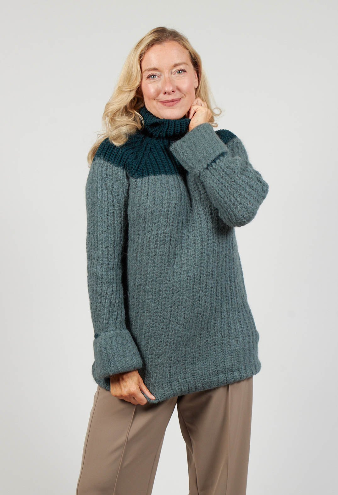 lady smiling wearing a knitted jumper in cypress shade