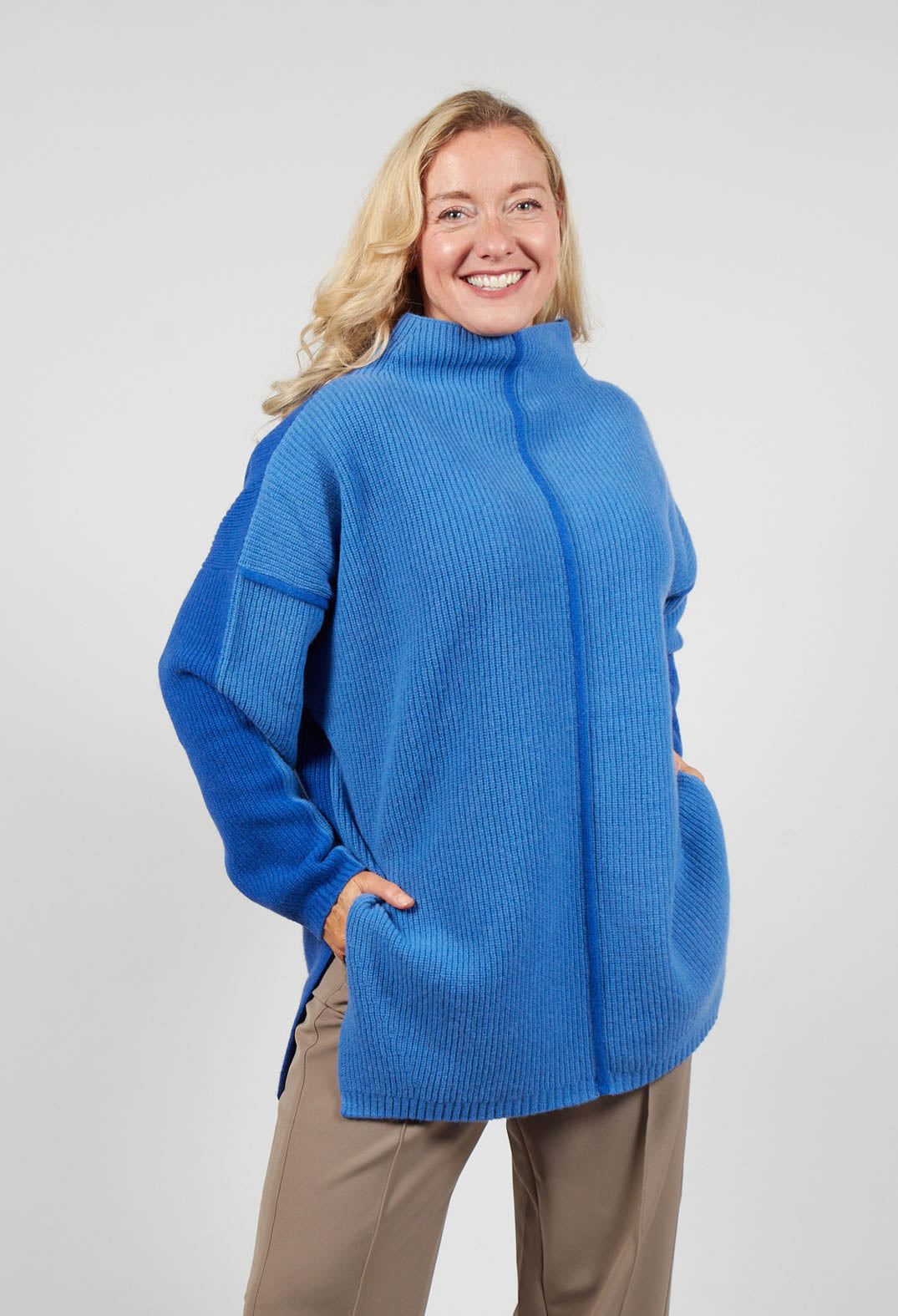 lady smiling wearing a Topaz blue jumper
