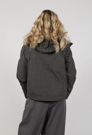behind shot of lady wearing a checked black and grey baria jacket