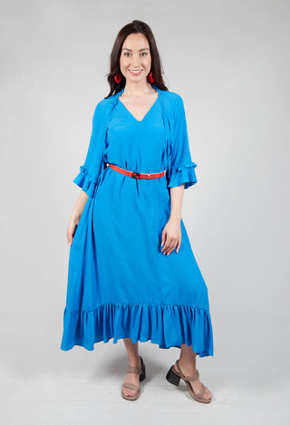 lady wearing a bold elegant dress with contrasting belt in blue
