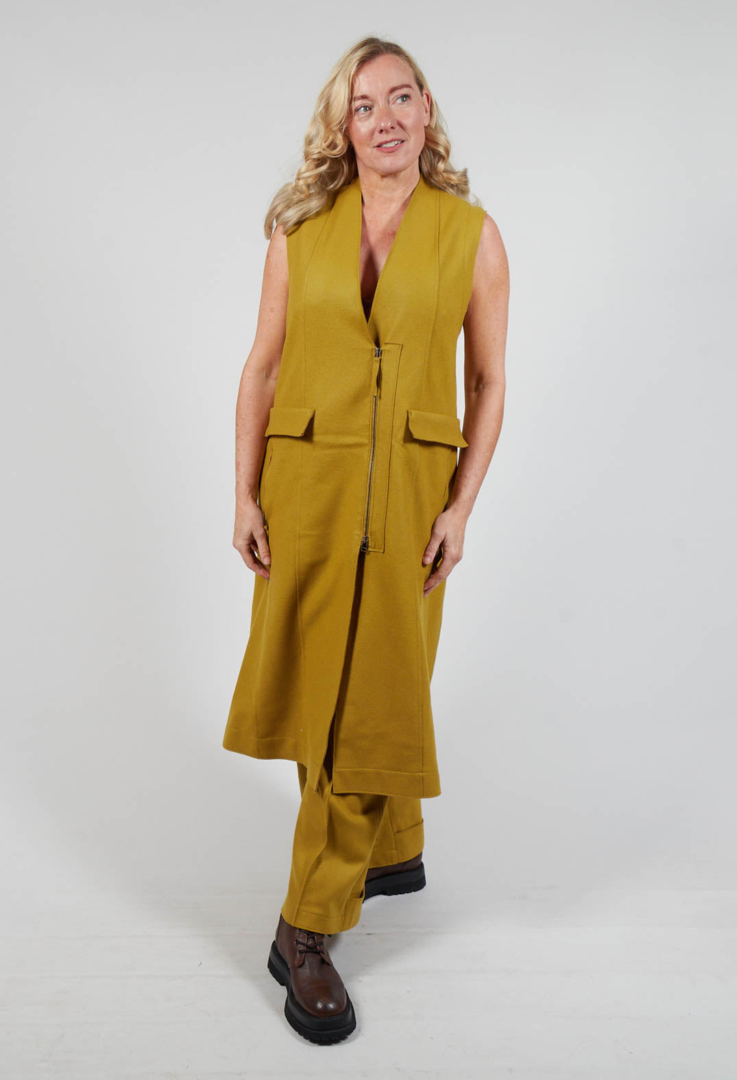 lady wearing a mustard campo vest and chunky brown boots