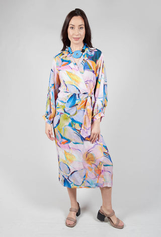 lady wearing a wrap over dress in eva print with neutral sandals
