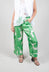 lady wearing wide leg silk trousers in green macro print