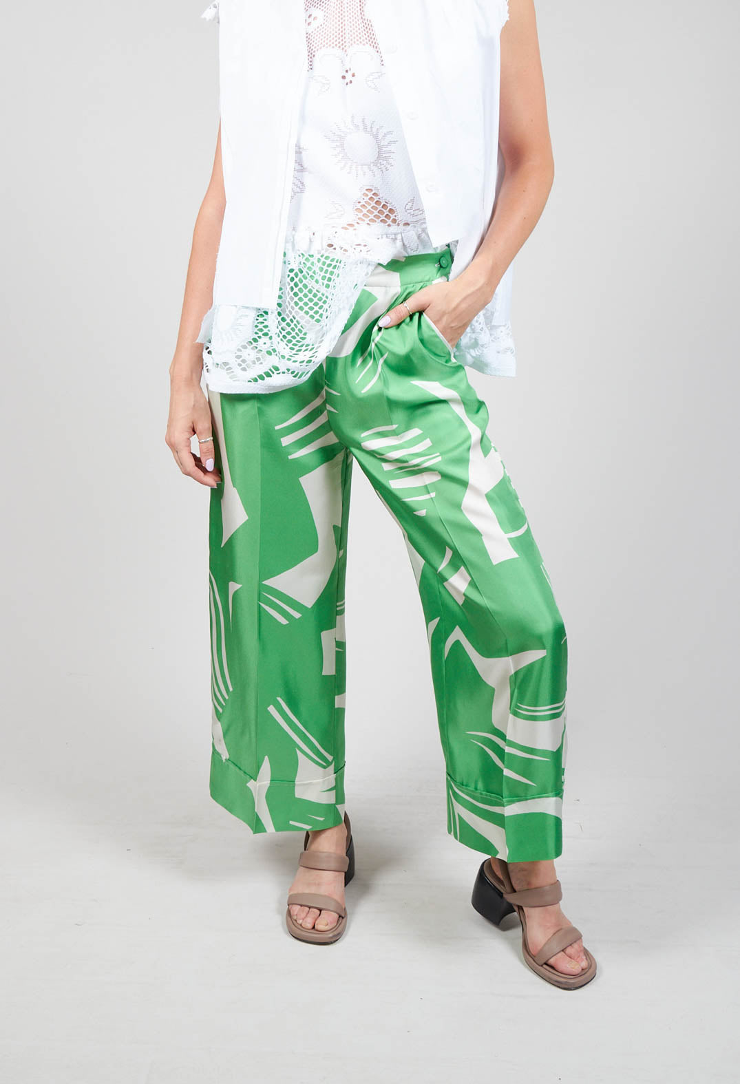 lady wearing wide leg silk trousers in green macro print
