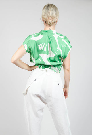 behind shot of silk blouse with capped sleeves