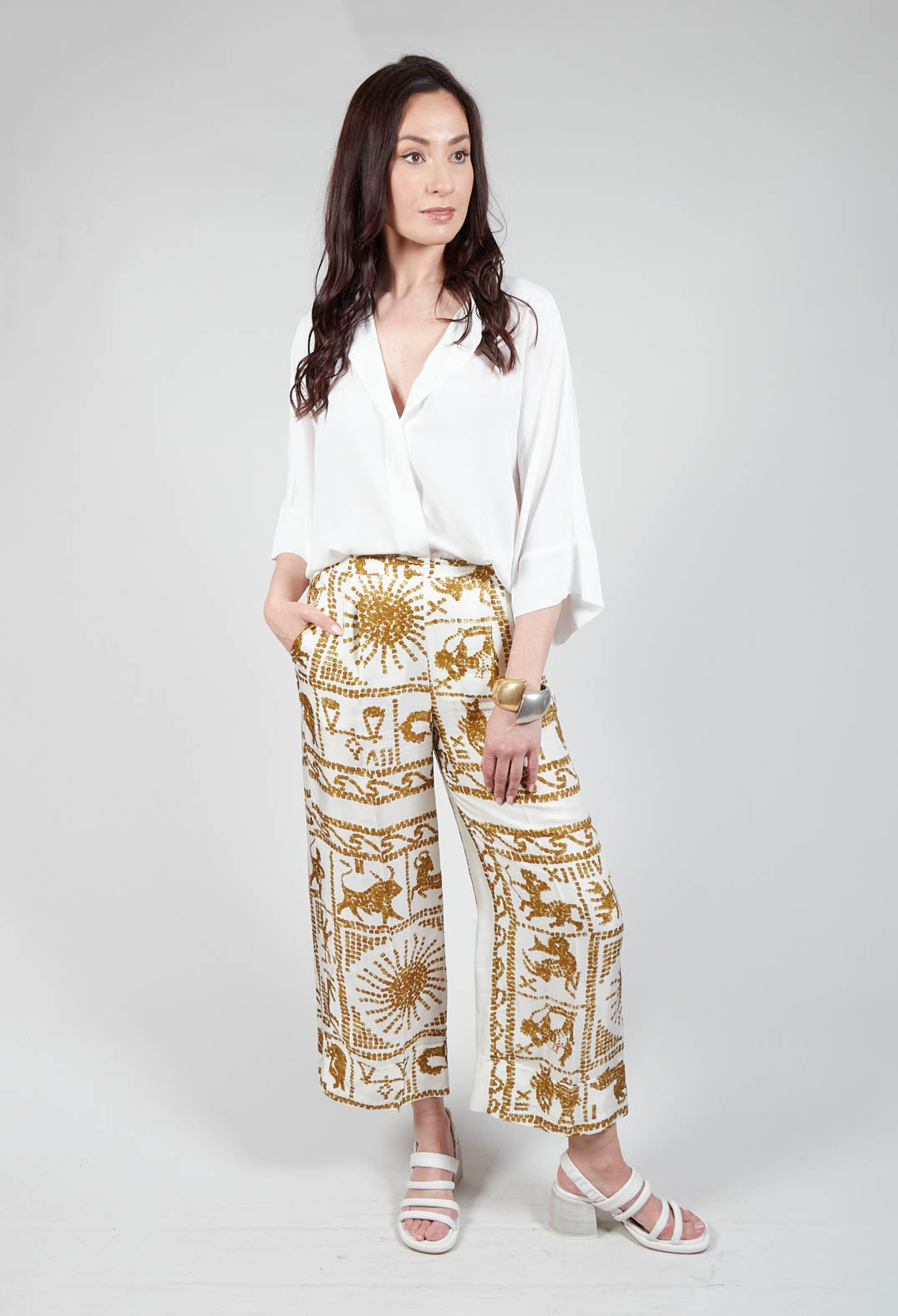 pretty lady wearing Beatrice B wide leg trousers in zodiac print