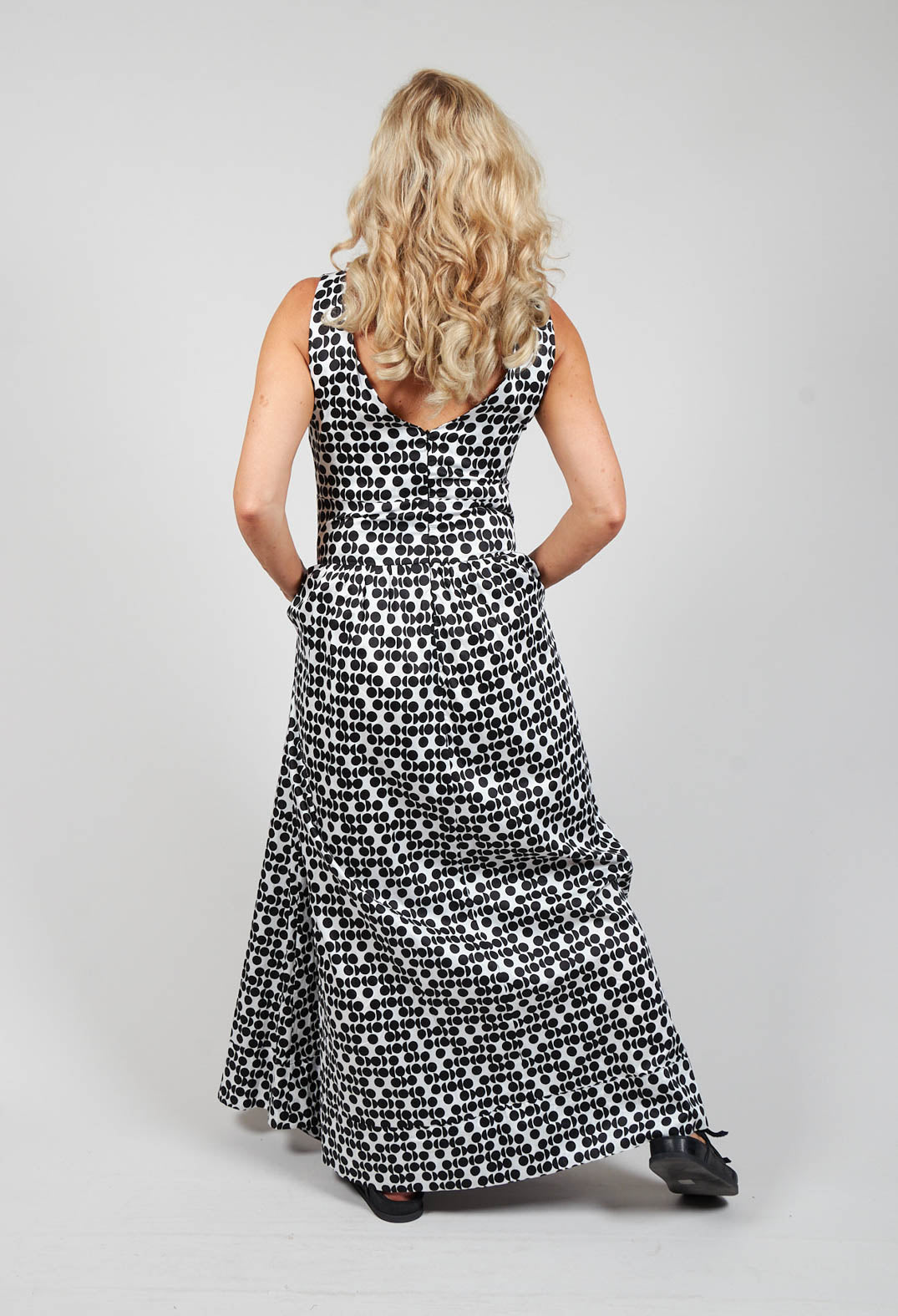 lady wearing a v neck maxi dress with black spots printed