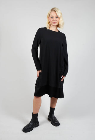 lady wearing a long sleeve black dress and boots