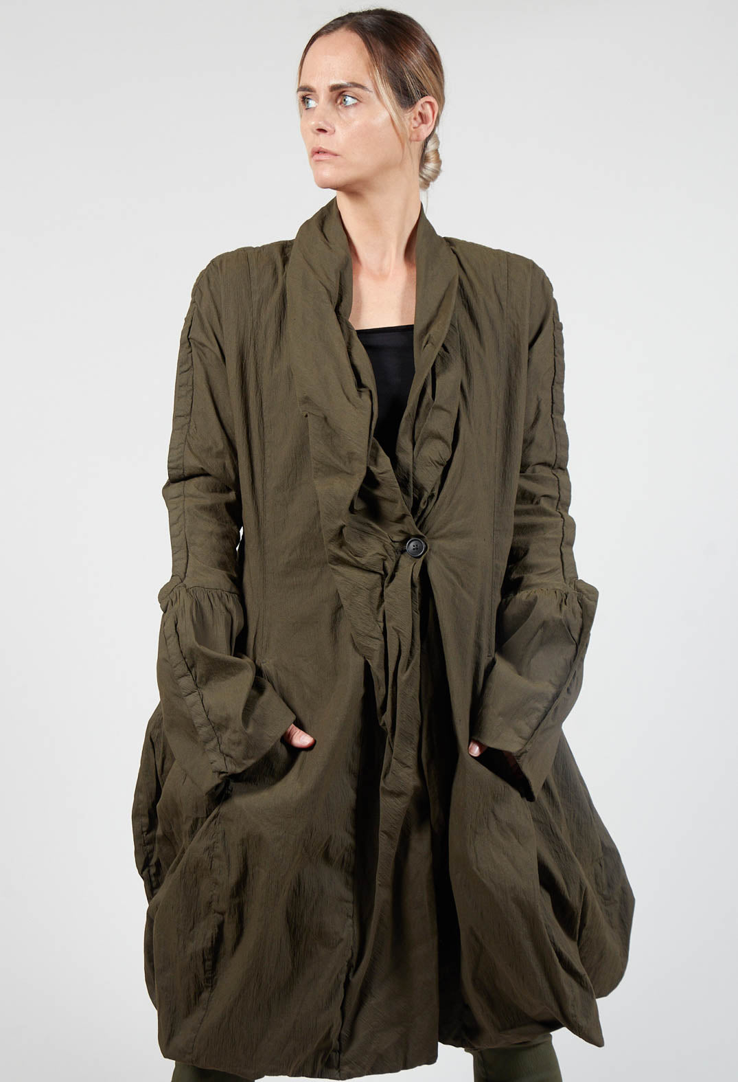 lady wearing a khaki coat with ruched fabric collar