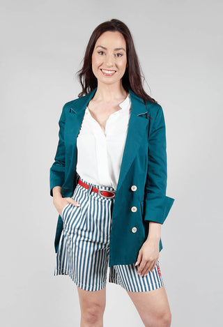 happy lady wearing green tailored jacket with collar detail and button fastening