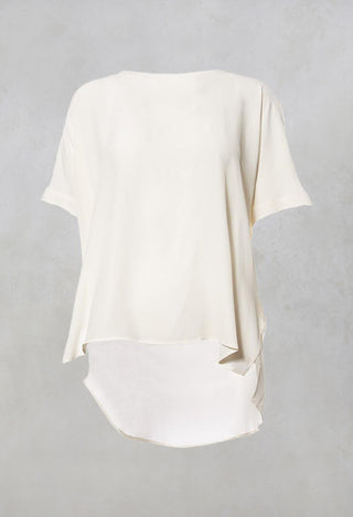 cream silk blouse with wide neck and short sleeves