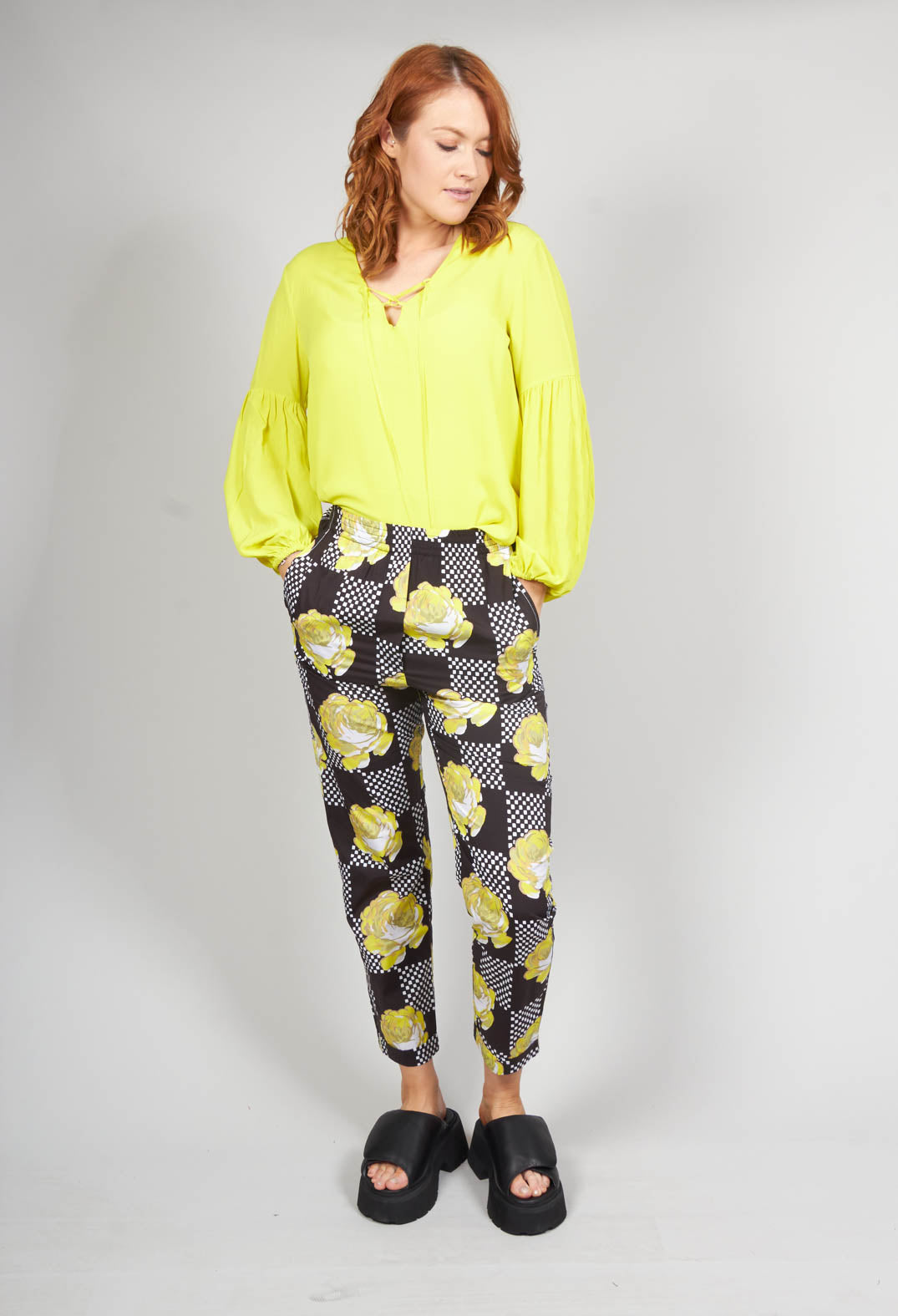lady wearing yellow print peg trousers