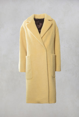 longline wool coat in cream yellow