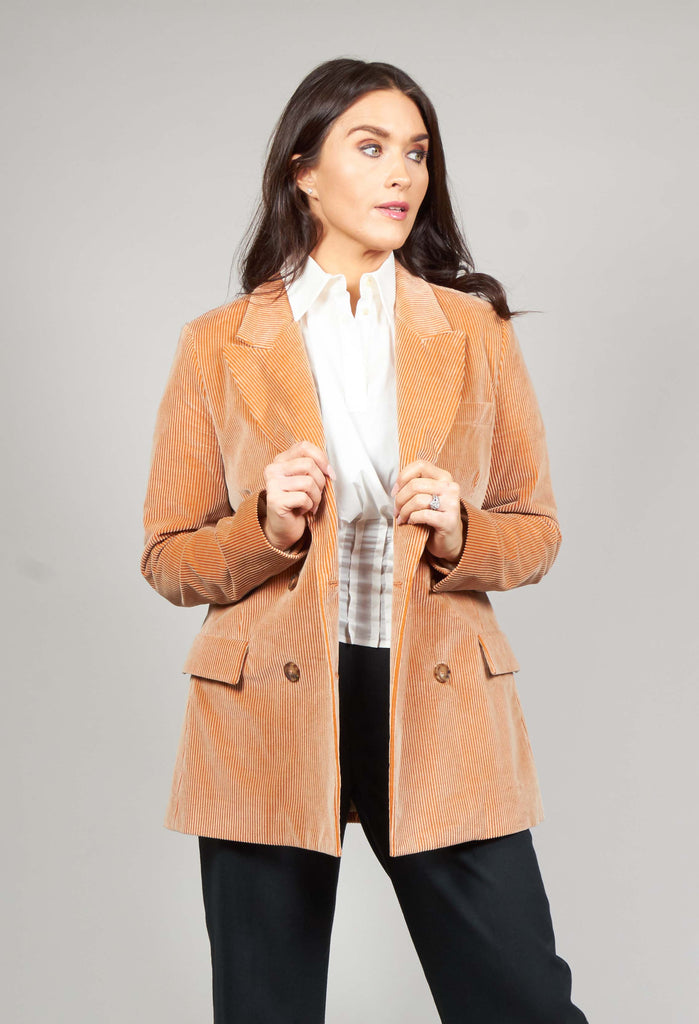 lady wearing the corduroy jacket in peach
