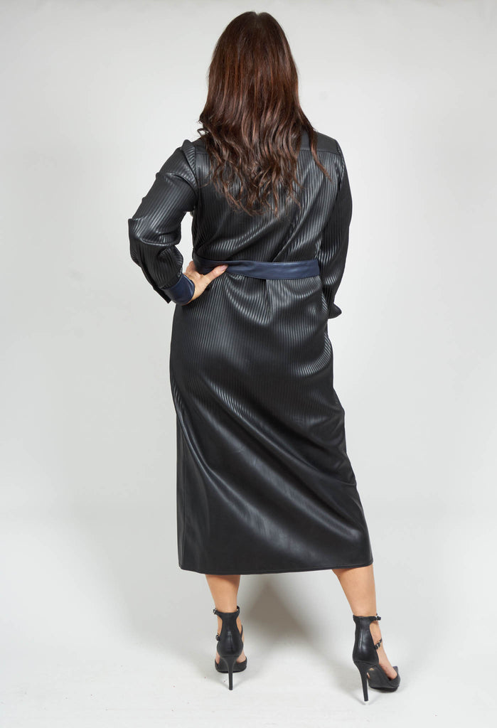 lady wearing a faux leather navy dress