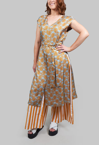 lady wearing a mustard sleeveless over dress 