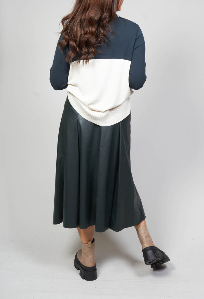 behind shot of polo neck in peacock green and cream