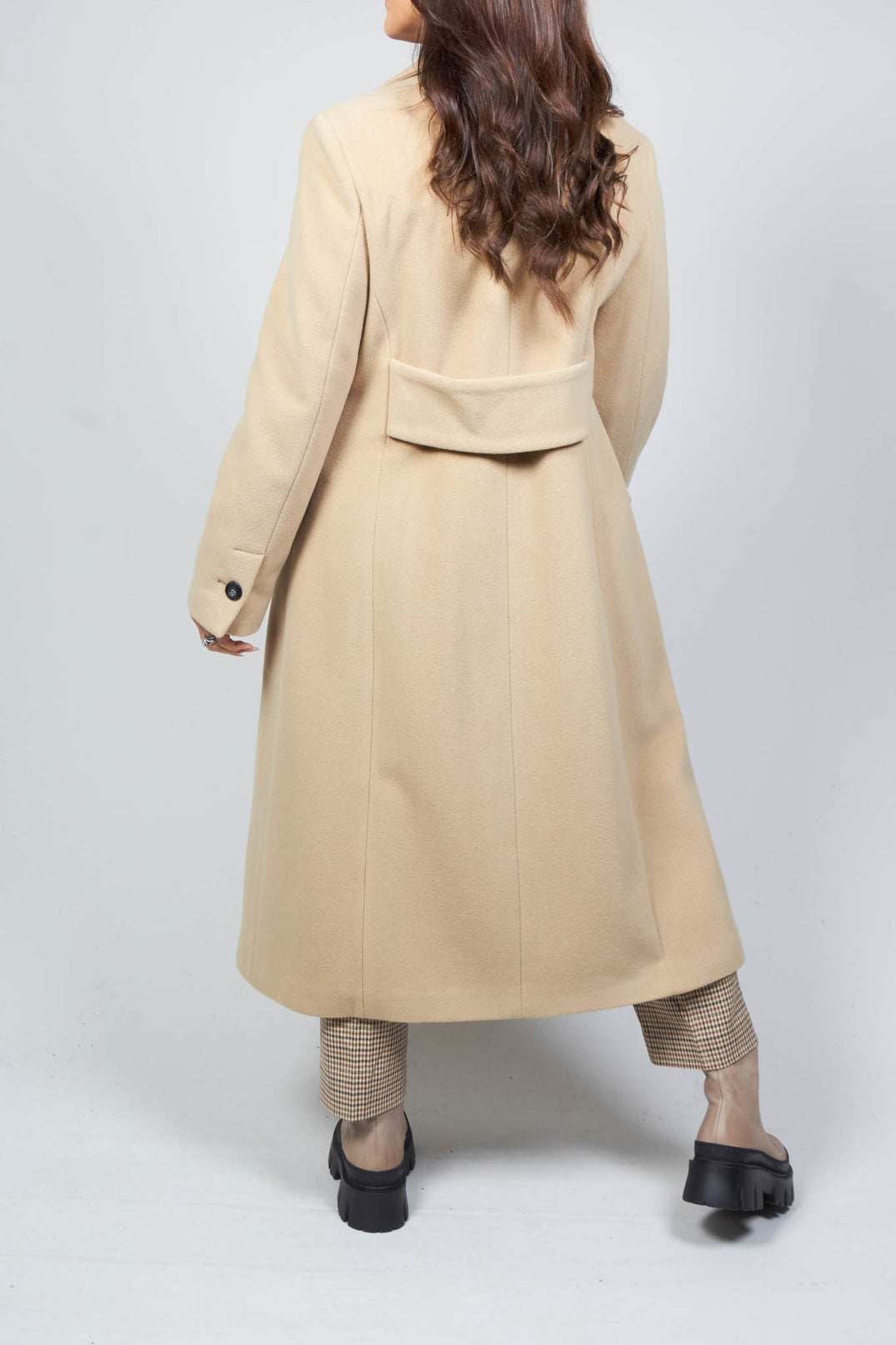 behind angle of tailored duster coat in camel