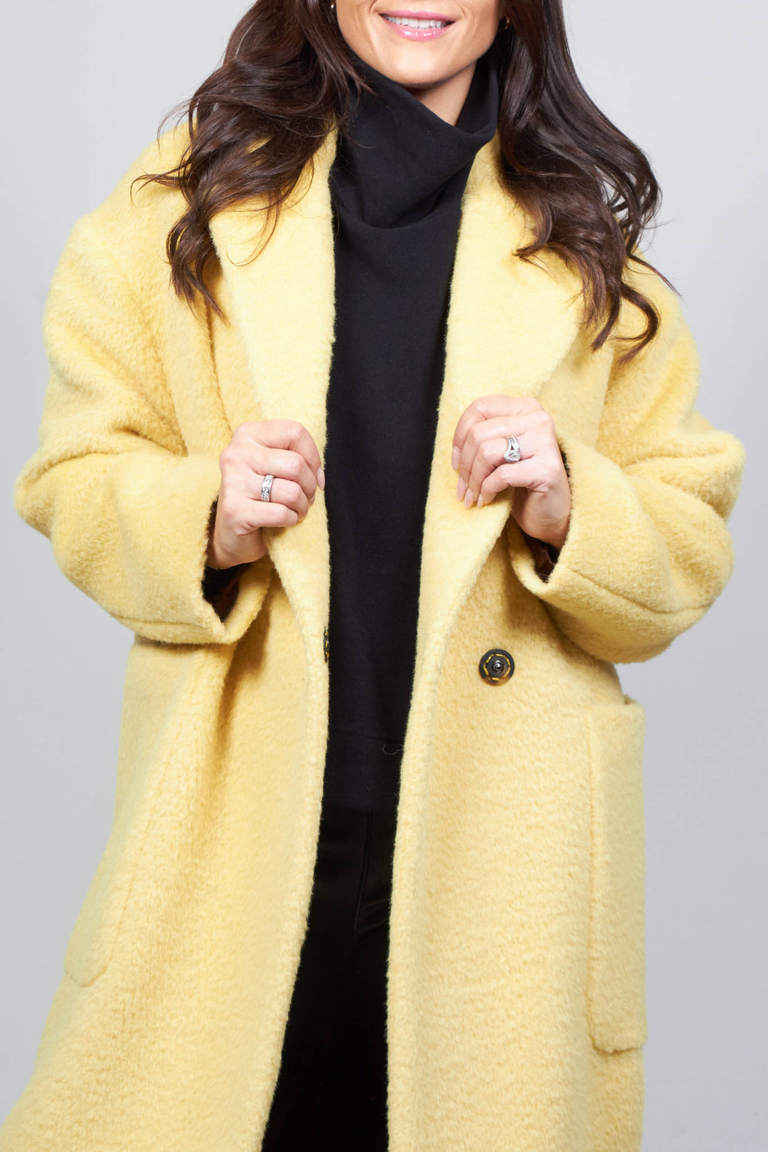 longline wool coat in cream yellow with button fastening and front pockets