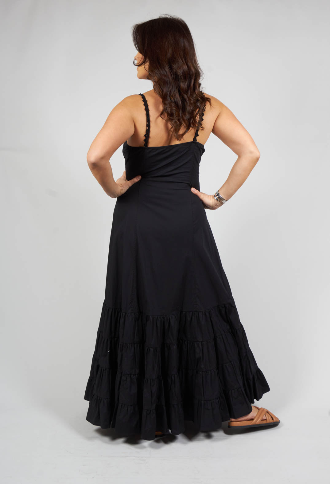 lady wearing a black tiered sleeveless dress