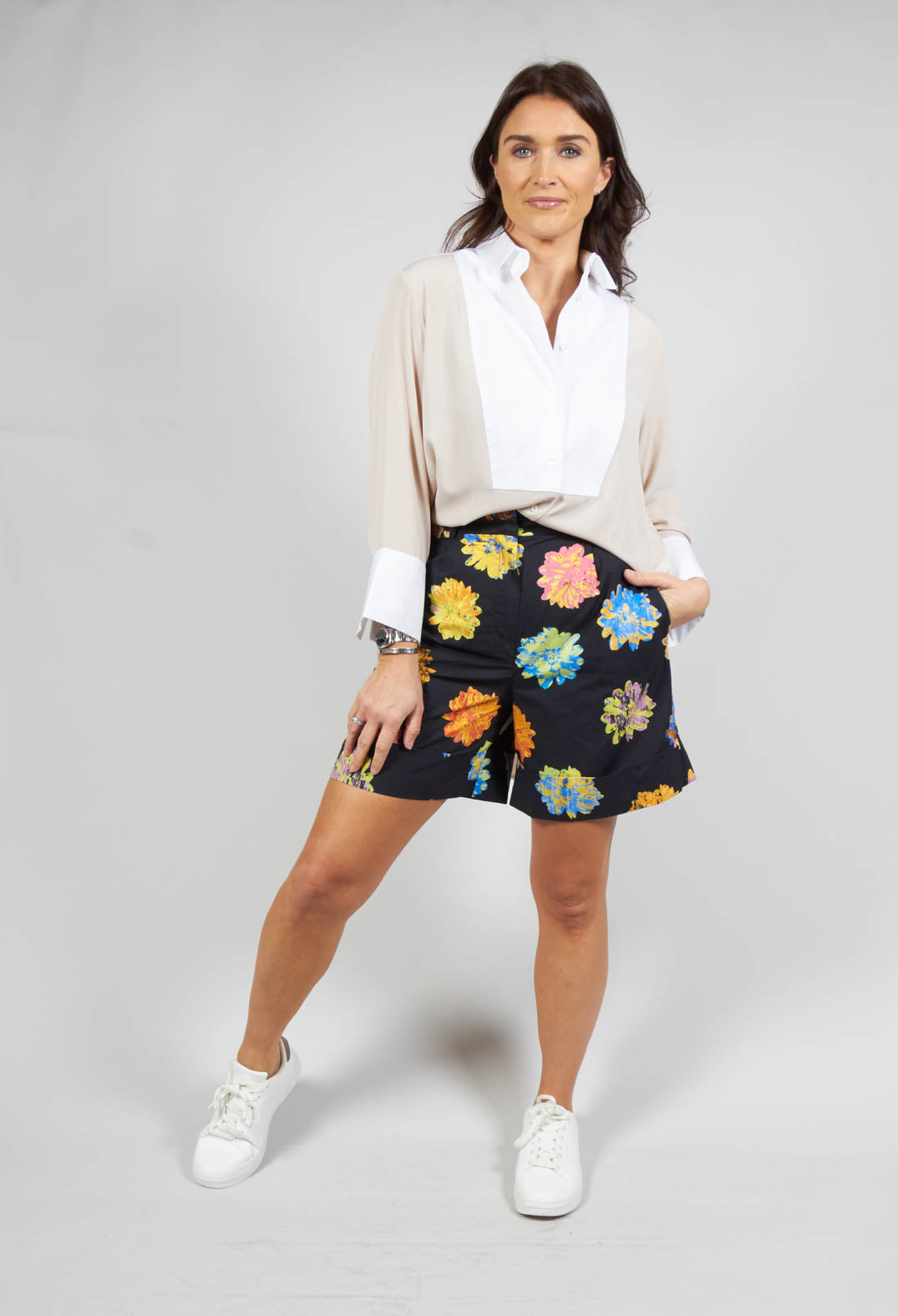 lady wearing high waited floral shorts with front pockets