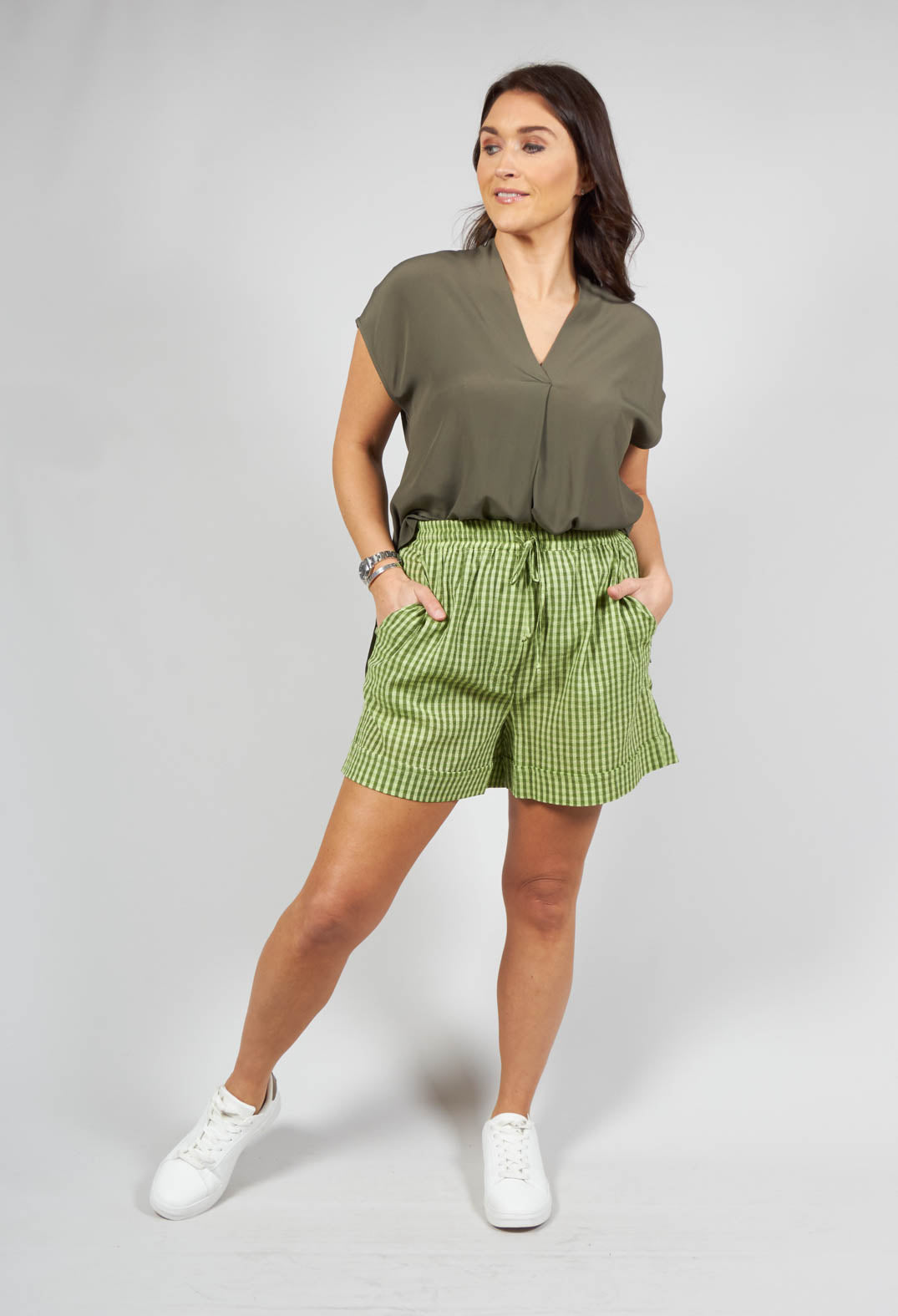 lady wearing turn up shorts in green check