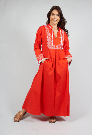red long sleeve dress with embroidery and a neck tie front