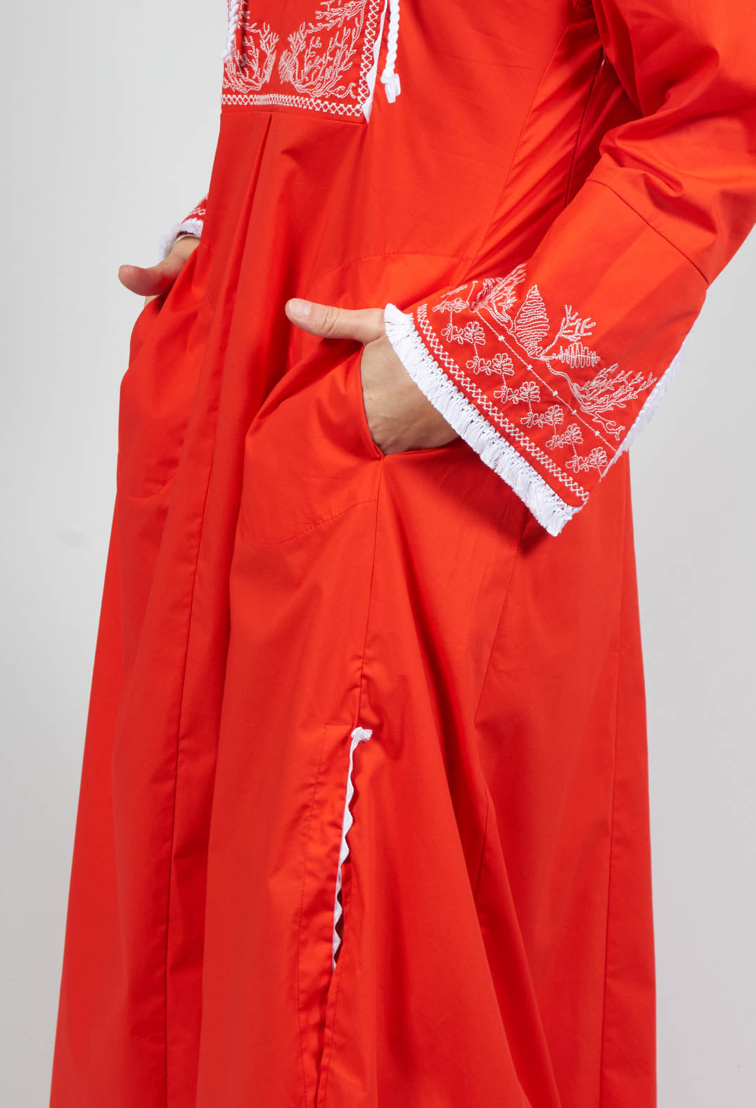red long sleeve dress with embroidery and front pockets
