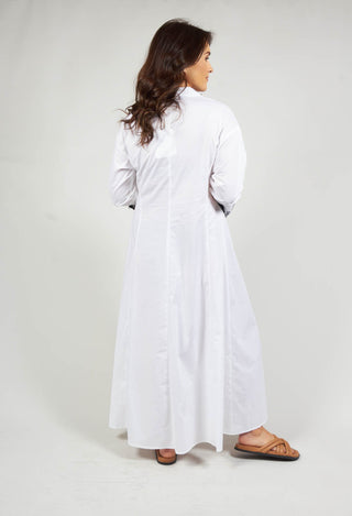 long sleeve white dress with embroidery detail and tie front at the neck
