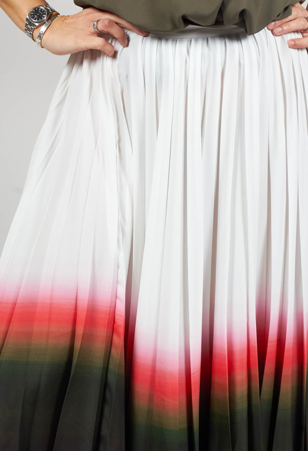 close up of pleated white faded skirt