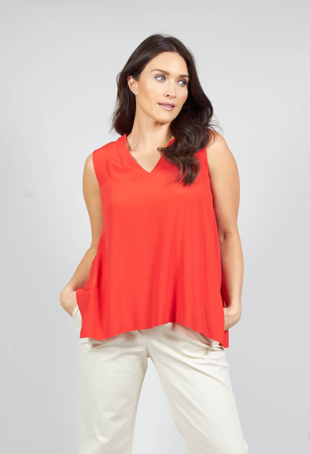 lady wearing a sleeveless red v neck loose fit top